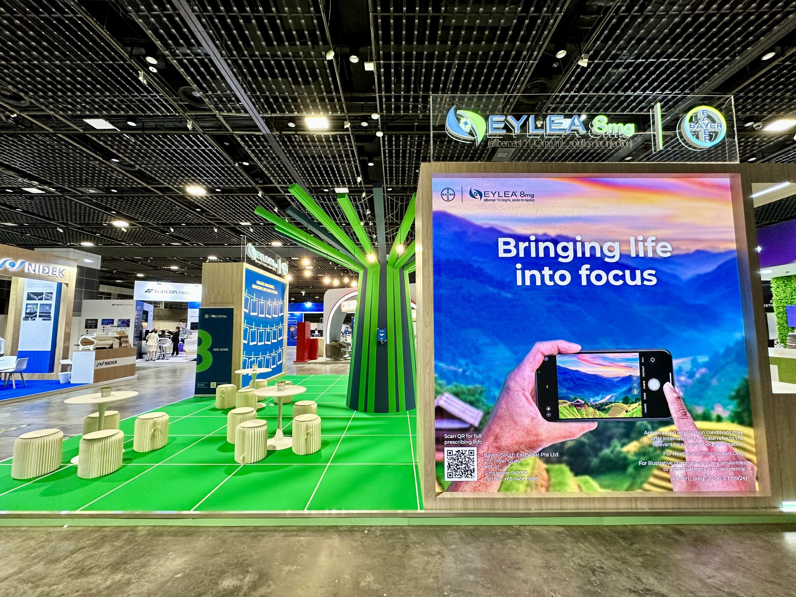 Side view of the APVRS Congress both with an open meeting space (left) and LED screen showcasing a carousel of key visuals, which features vacation destinations
